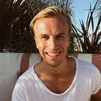 Hannes smiling in white t-shirt
